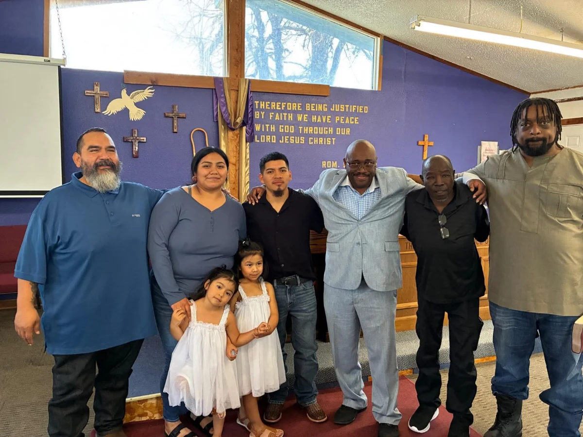Church members and children standing together in the sanctuary