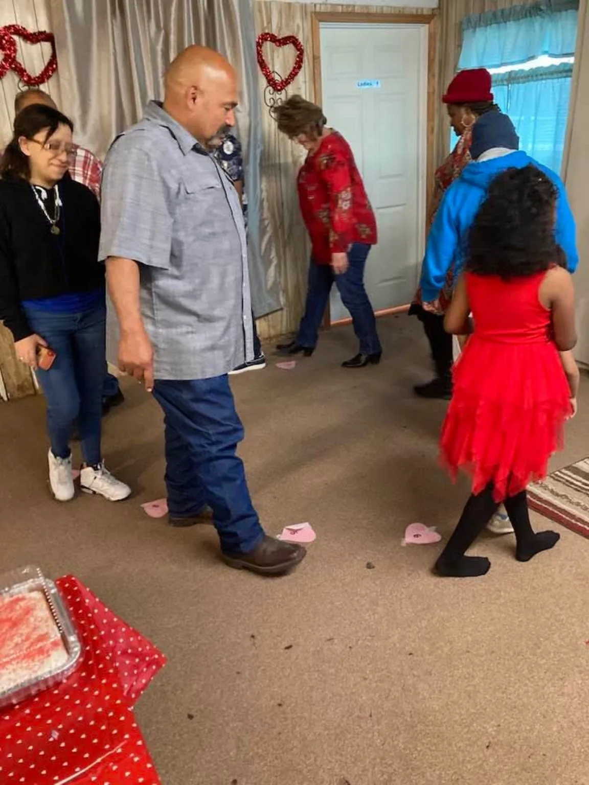Adults and children gathering for fellowship inside the church