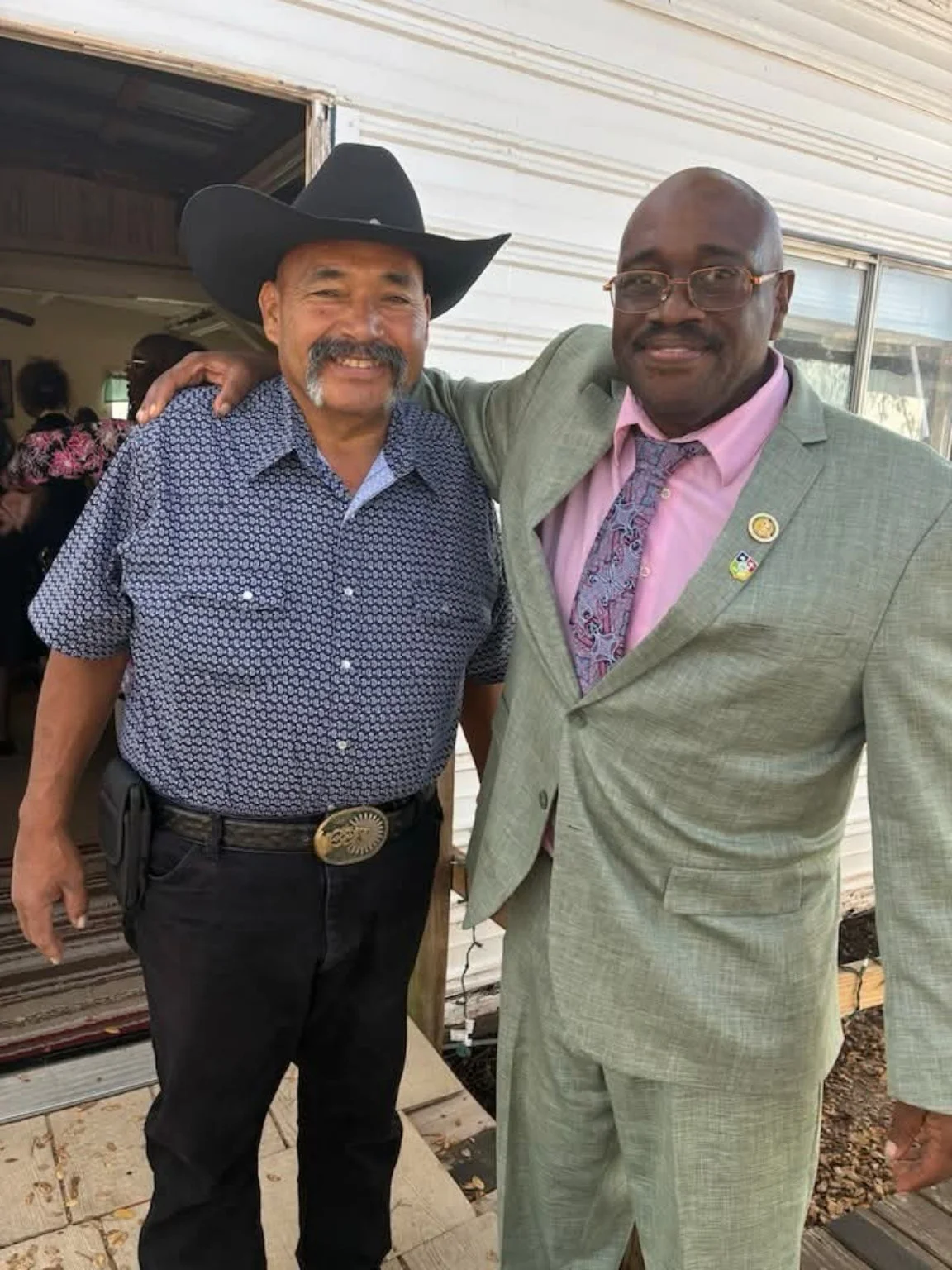 Pastor Cedric Burdett standing beside a friend outside the church